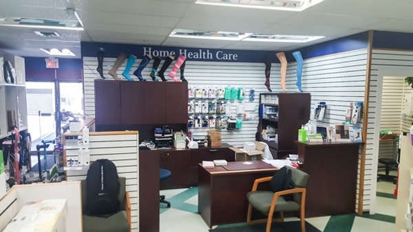 a Home Health Care section of a pharmacy with a desk and chair for customer service