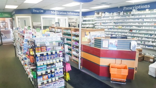 over the counter products in front of the pharmacy counter of a pharmacy store